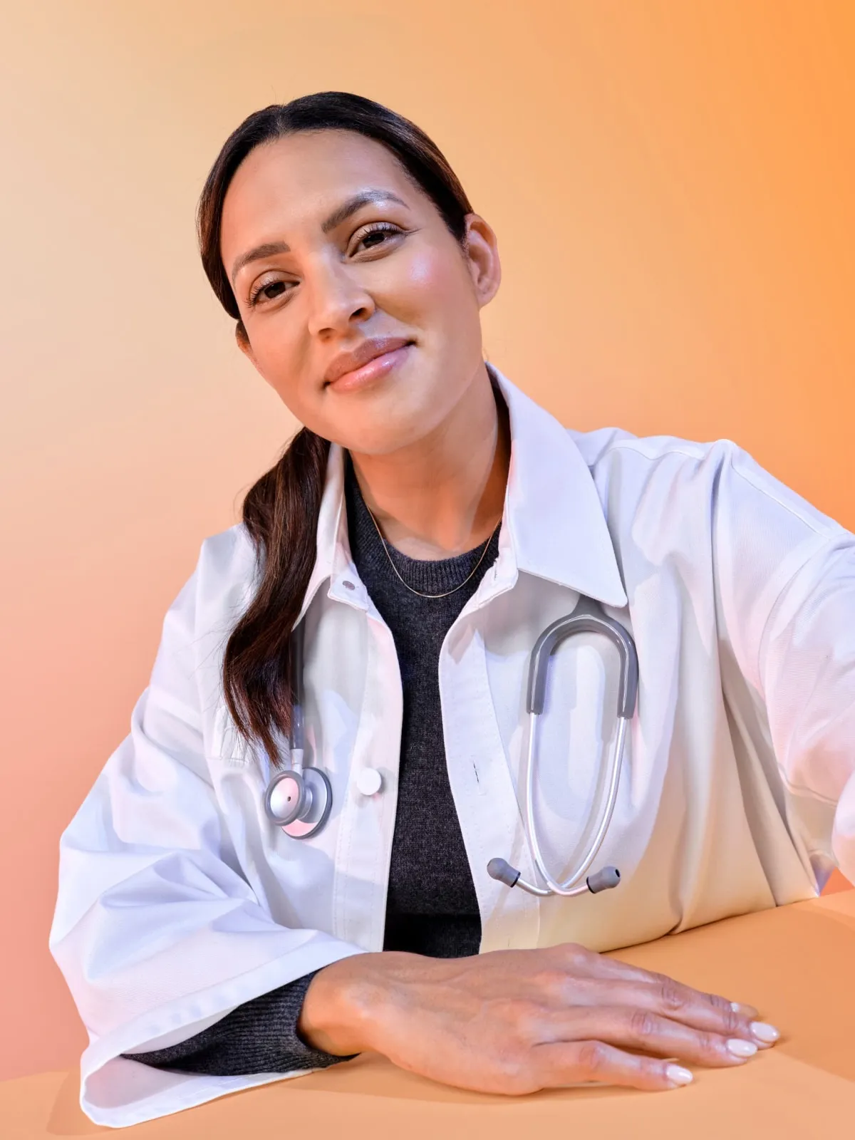 Provider smiling with a bright orange backdrop